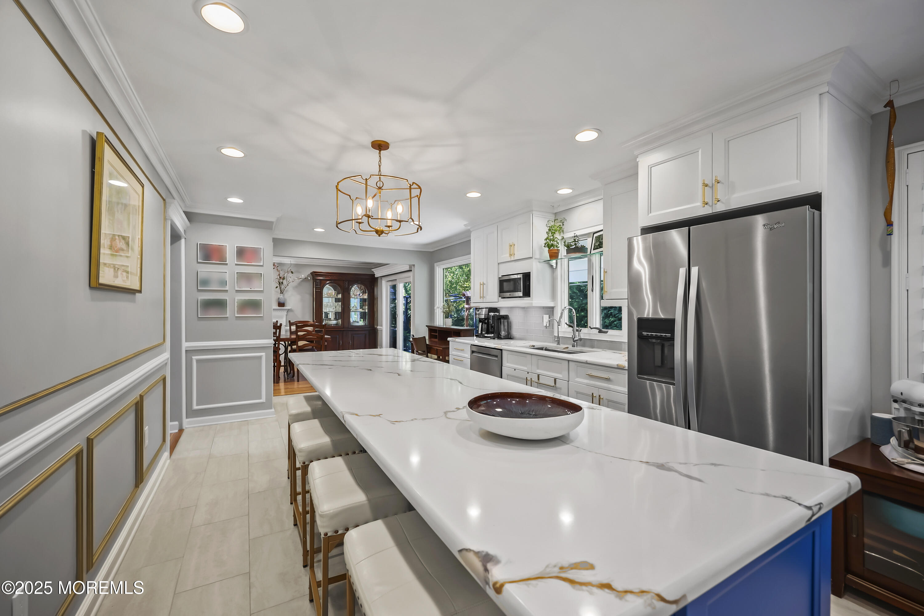 22 Riley Road Morganville, NJ 07751 - Photo 11 of 28 a kitchen with stainless steel appliances a dining table chairs and refrigerator
