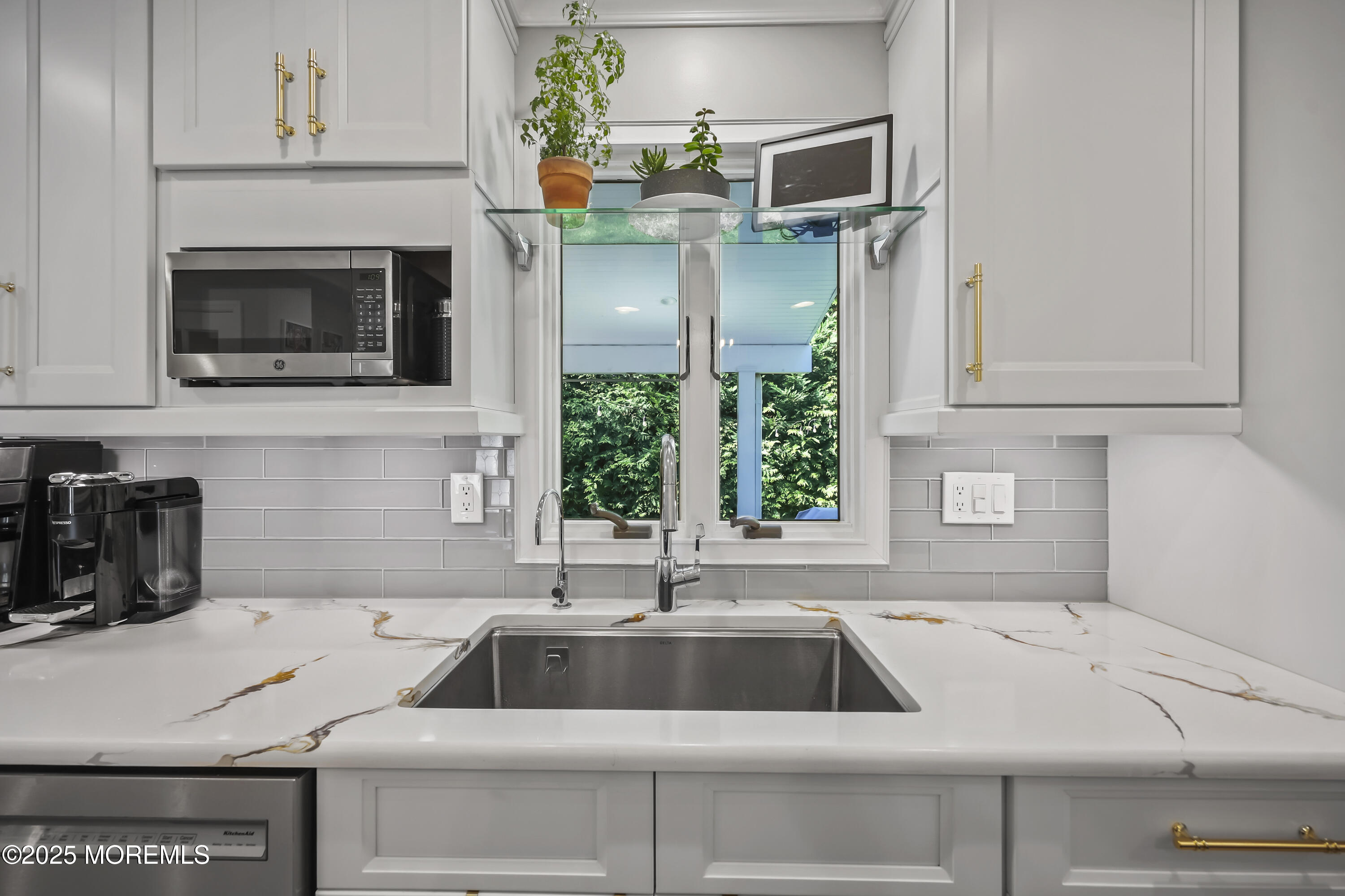 22 Riley Road Morganville, NJ 07751 - Photo 13 of 28 a kitchen with a sink and a microwave