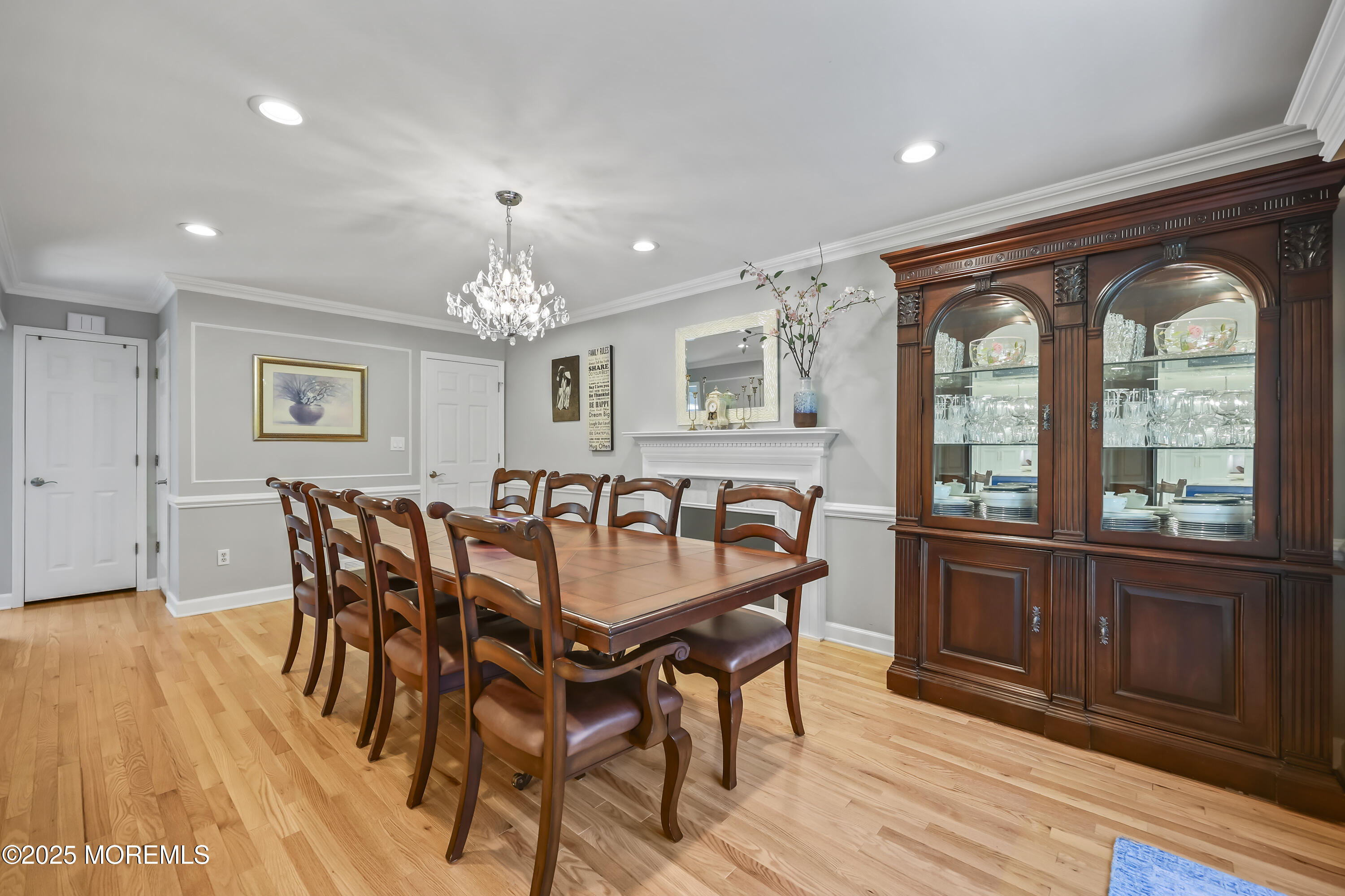 22 Riley Road Morganville, NJ 07751 - Photo 14 of 28 a dining room with furniture a chandelier and wooden floor