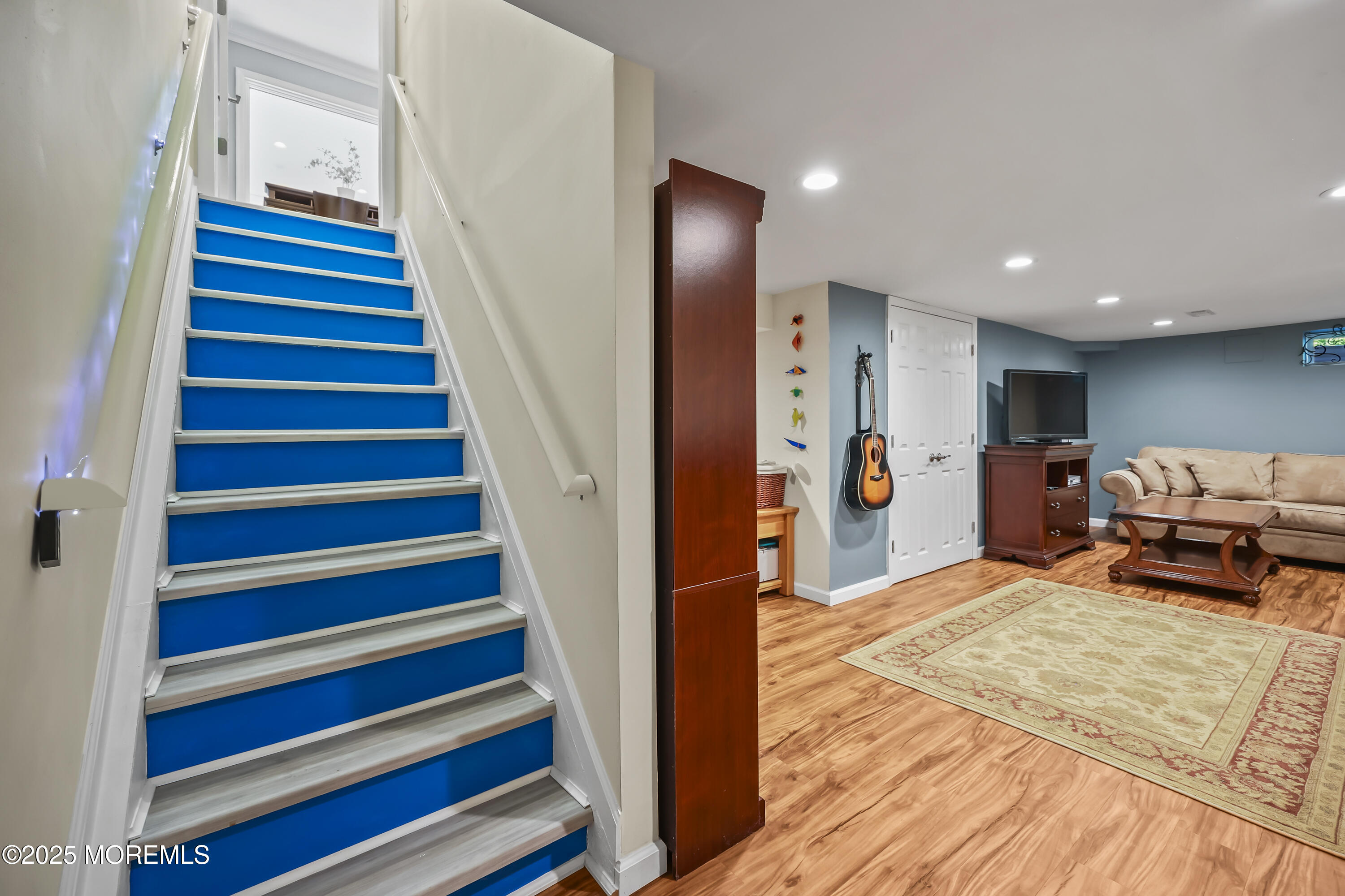 22 Riley Road Morganville, NJ 07751 - Photo 16 of 28 a living room with furniture and a stairs