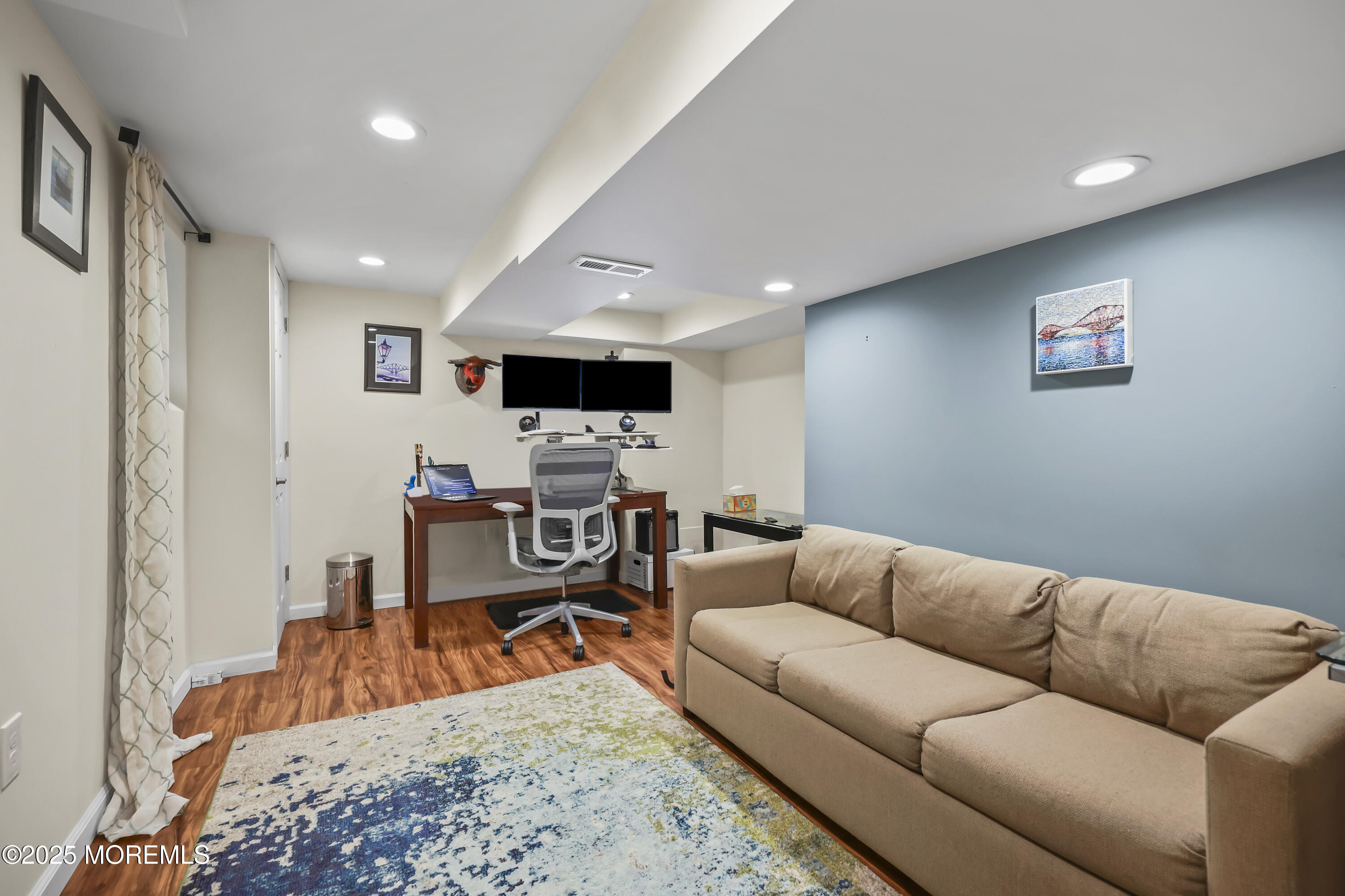 22 Riley Road Morganville, NJ 07751 - Photo 18 of 28 a living room with furniture and a flat screen tv
