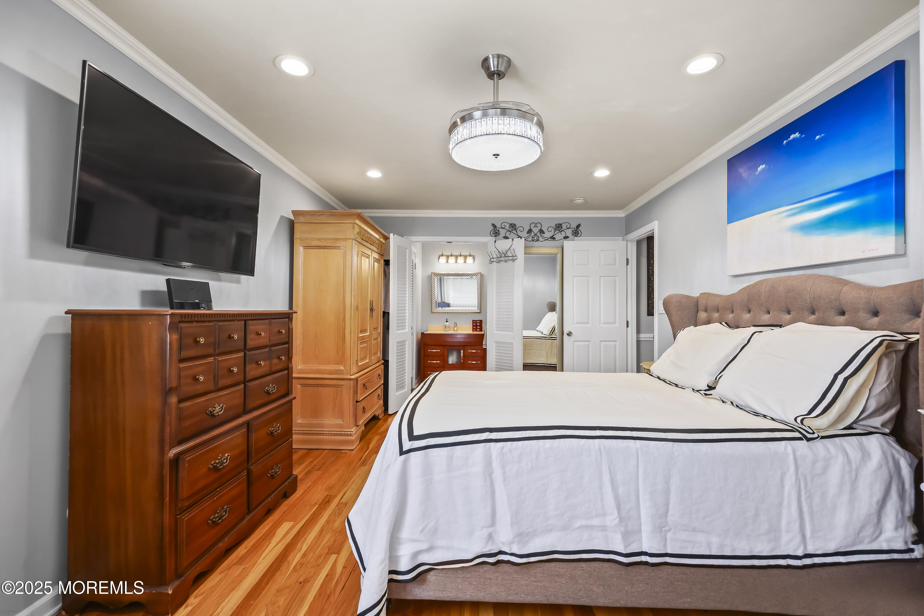 22 Riley Road Morganville, NJ 07751 - Photo 19 of 28 a large bedroom with a bed and a flat screen tv