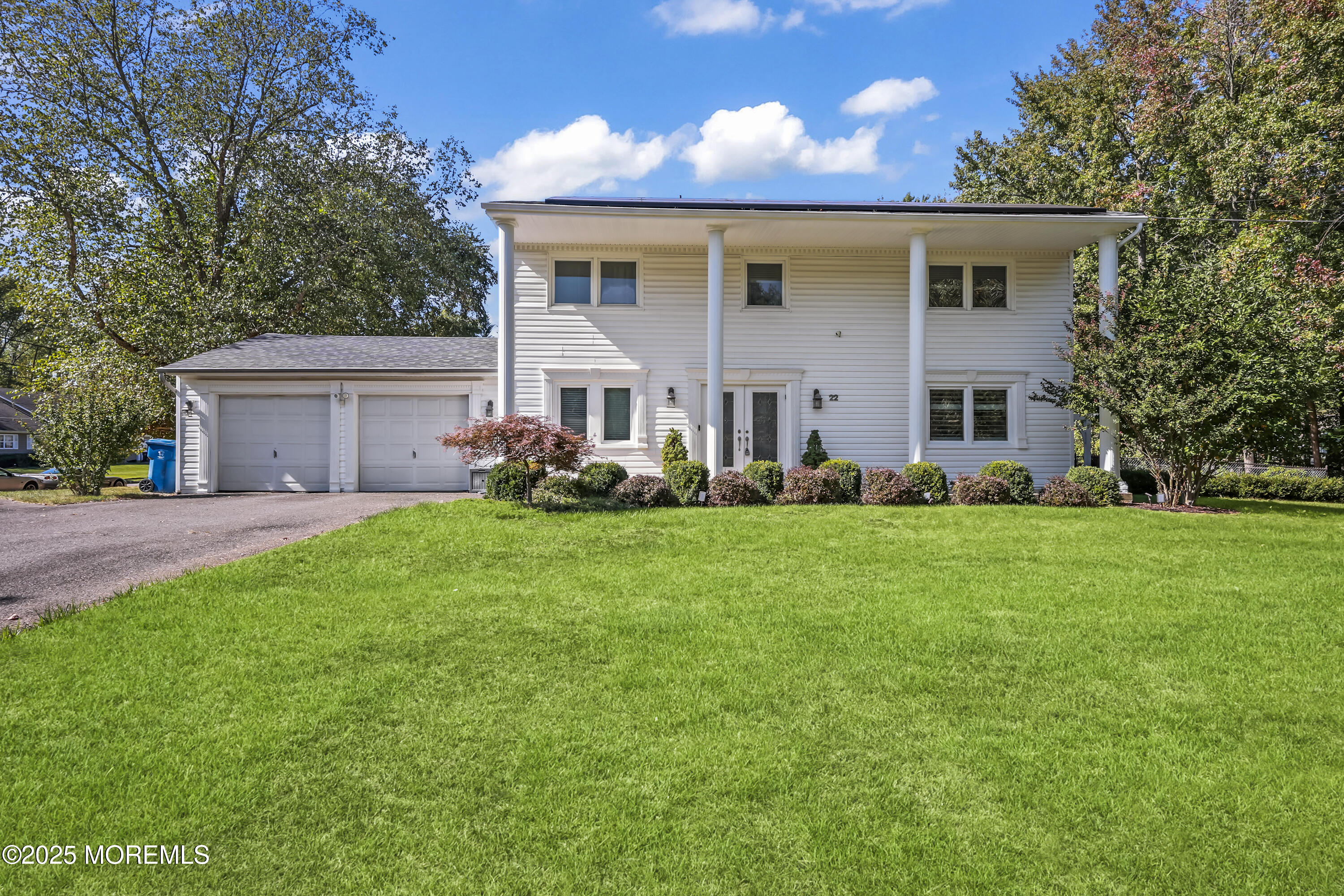 22 Riley Road Morganville, NJ 07751 - Photo 2 of 28 a front view of house with yard and green space