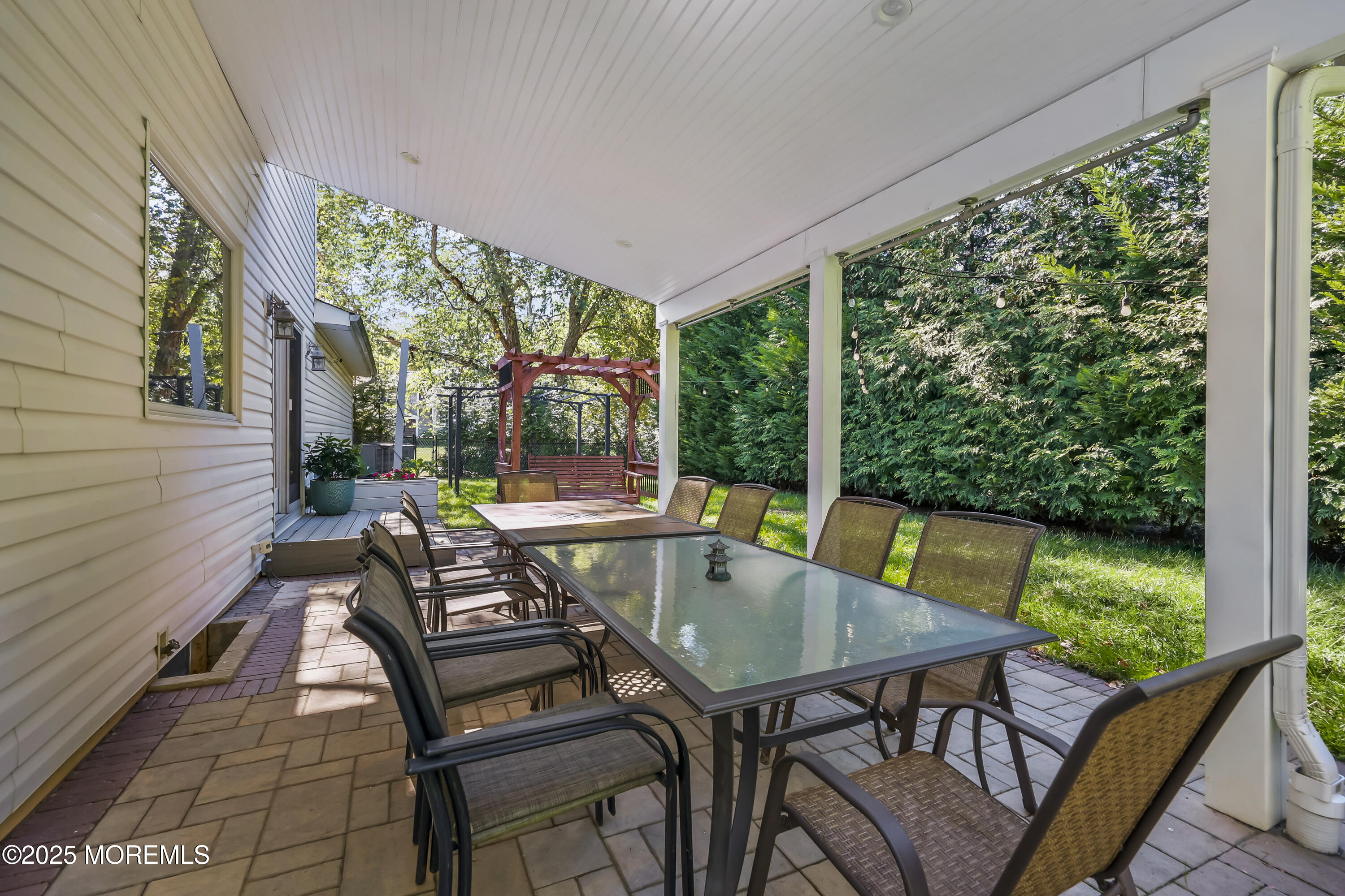 22 Riley Road Morganville, NJ 07751 - Photo 25 of 28 a view of a patio with a table chairs and a backyard