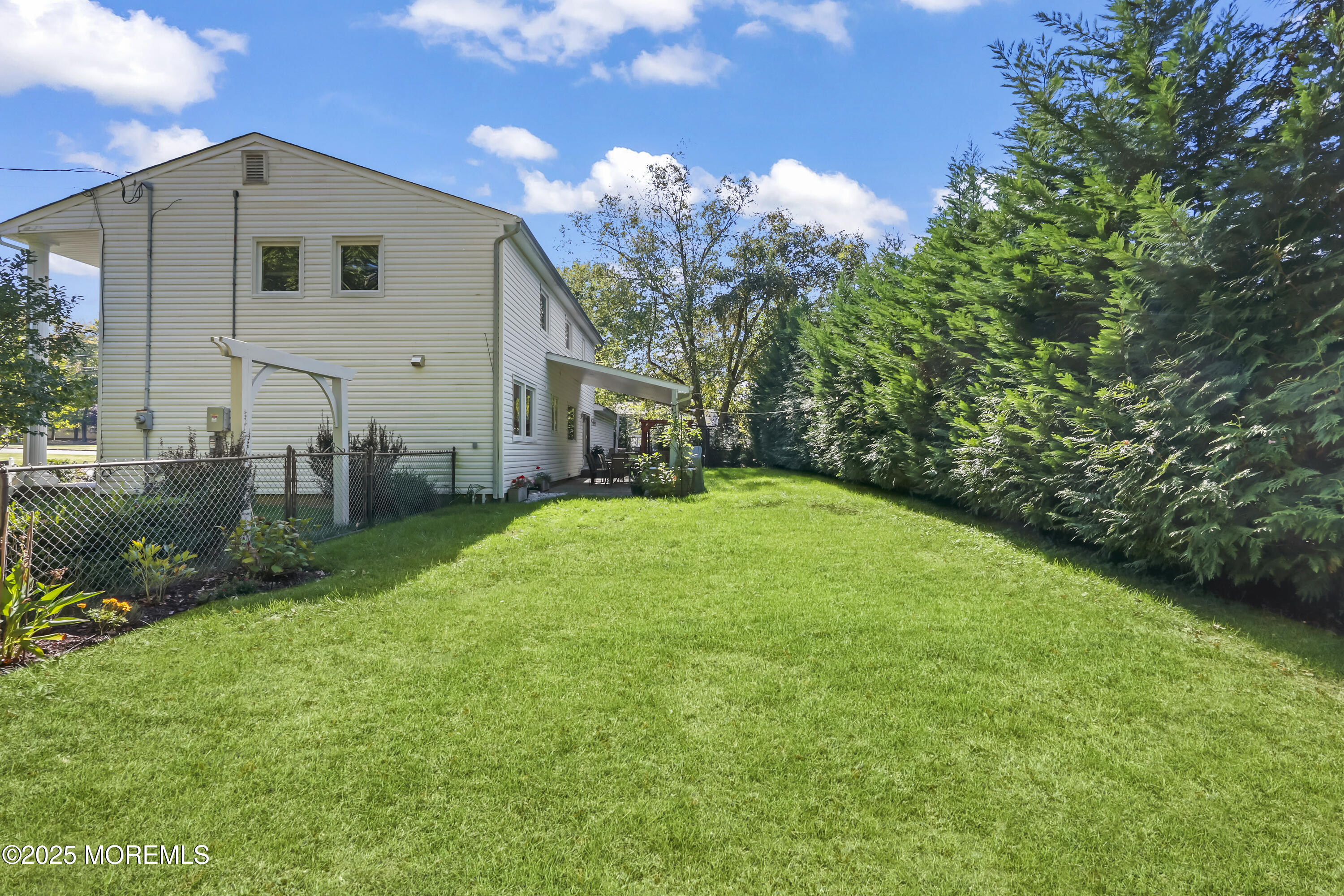 22 Riley Road Morganville, NJ 07751 - Photo 27 of 28 a front view of house with yard and green space