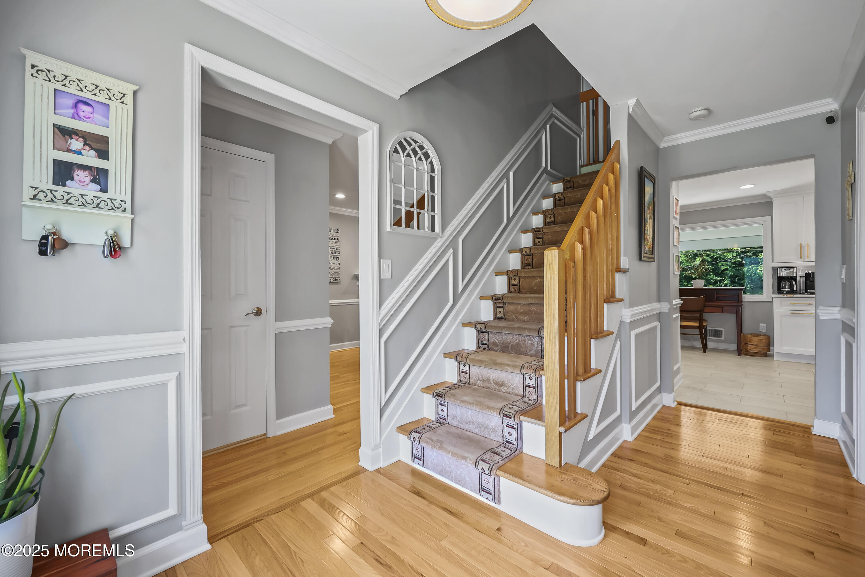 22 Riley Road Morganville, NJ 07751 - Photo 4 of 28 a view of entryway with wooden floor and stairs