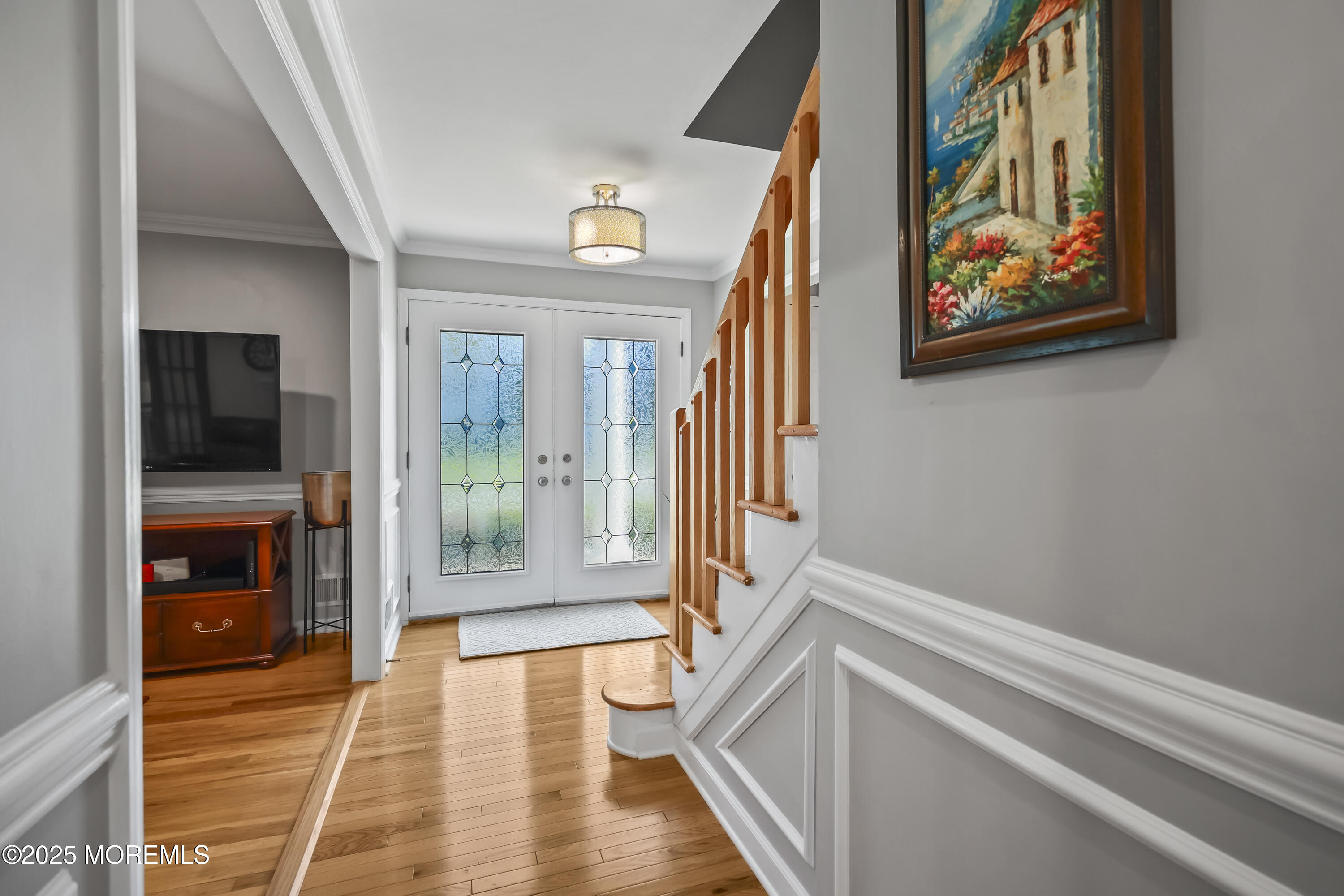 22 Riley Road Morganville, NJ 07751 - Photo 5 of 28 a view of an entryway with wooden floor and a livingroom