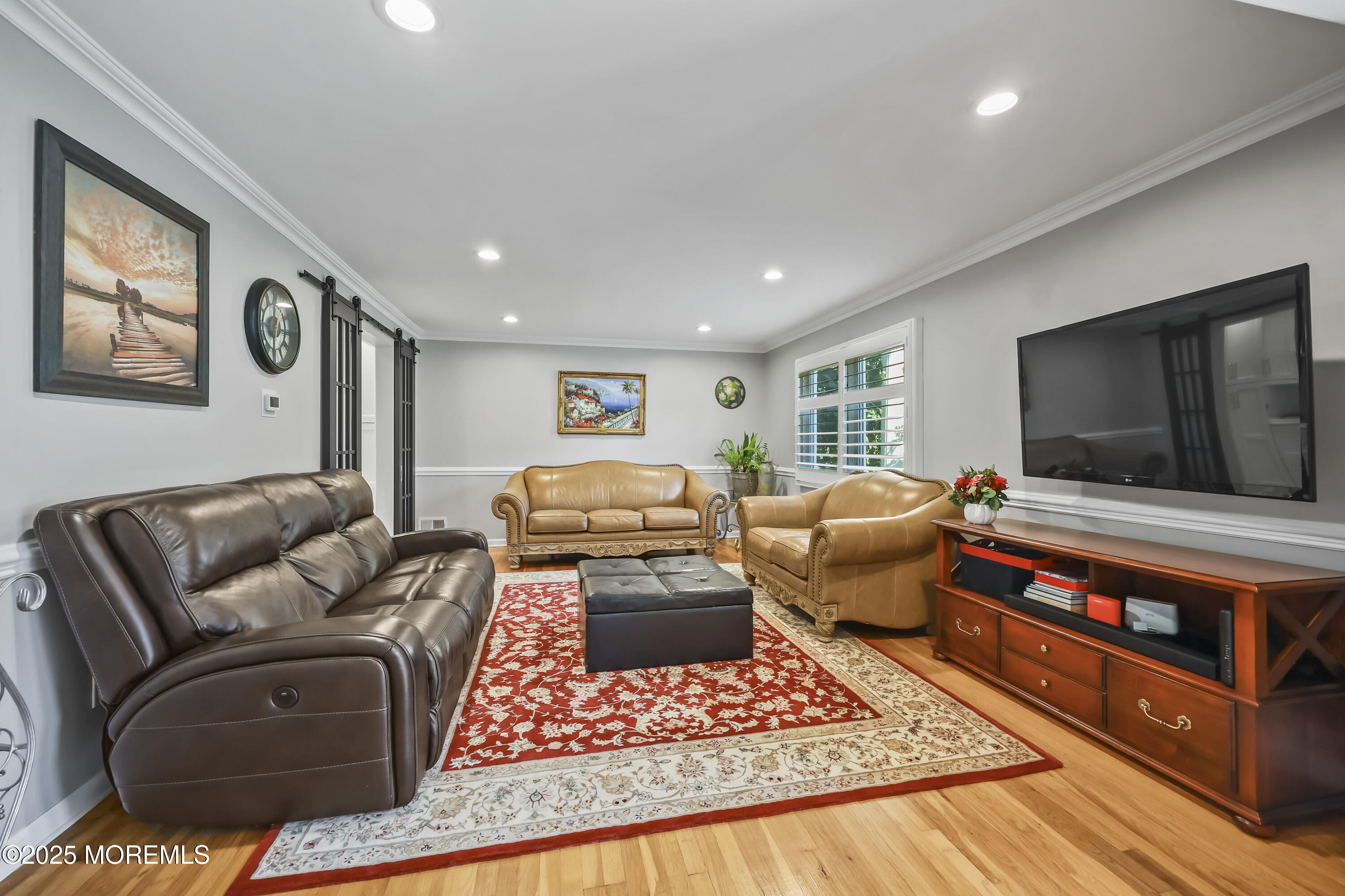 22 Riley Road Morganville, NJ 07751 - Photo 6 of 28 a living room with furniture and a flat screen tv