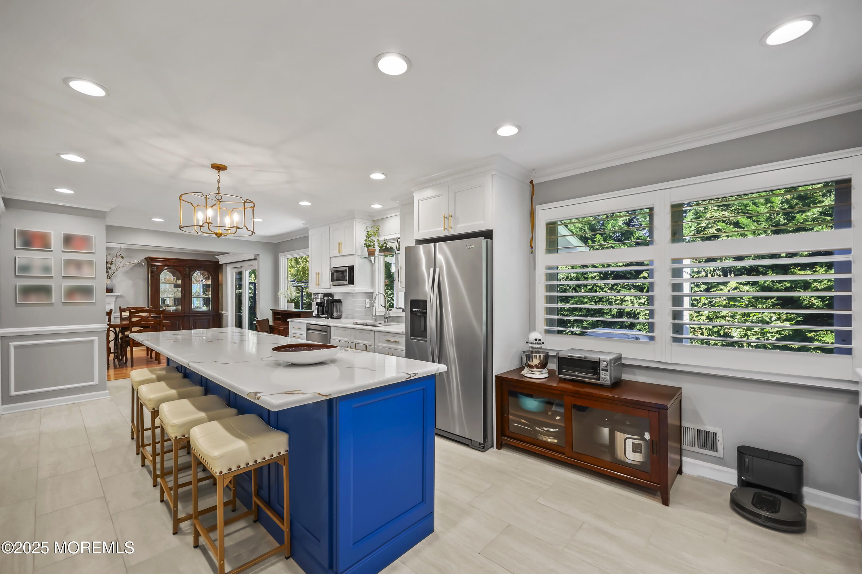 22 Riley Road Morganville, NJ 07751 - Photo 10 of 28 a kitchen with stainless steel appliances granite countertop a refrigerator a sink dishwasher a stove and a dining table with wooden floor