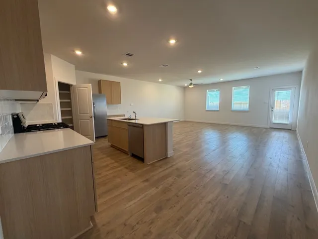 a view of kitchen with stainless steel appliances granite countertop wooden cabinets and a granite counter tops
