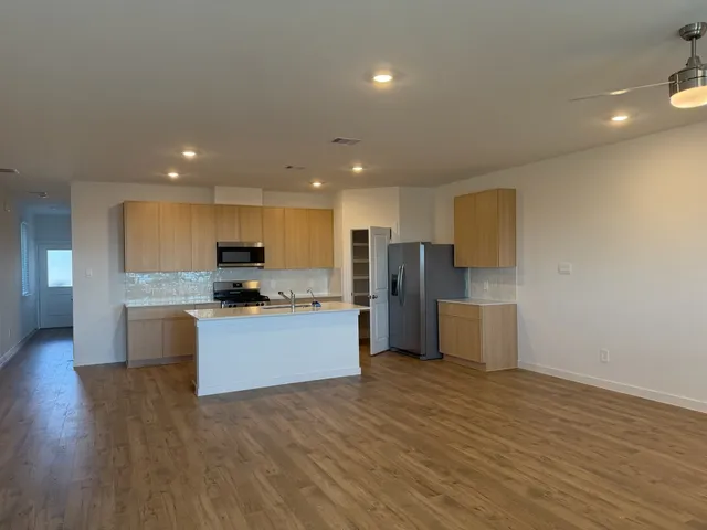 a kitchen with a refrigerator and a microwave