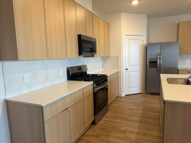 a kitchen with a refrigerator stove and microwave