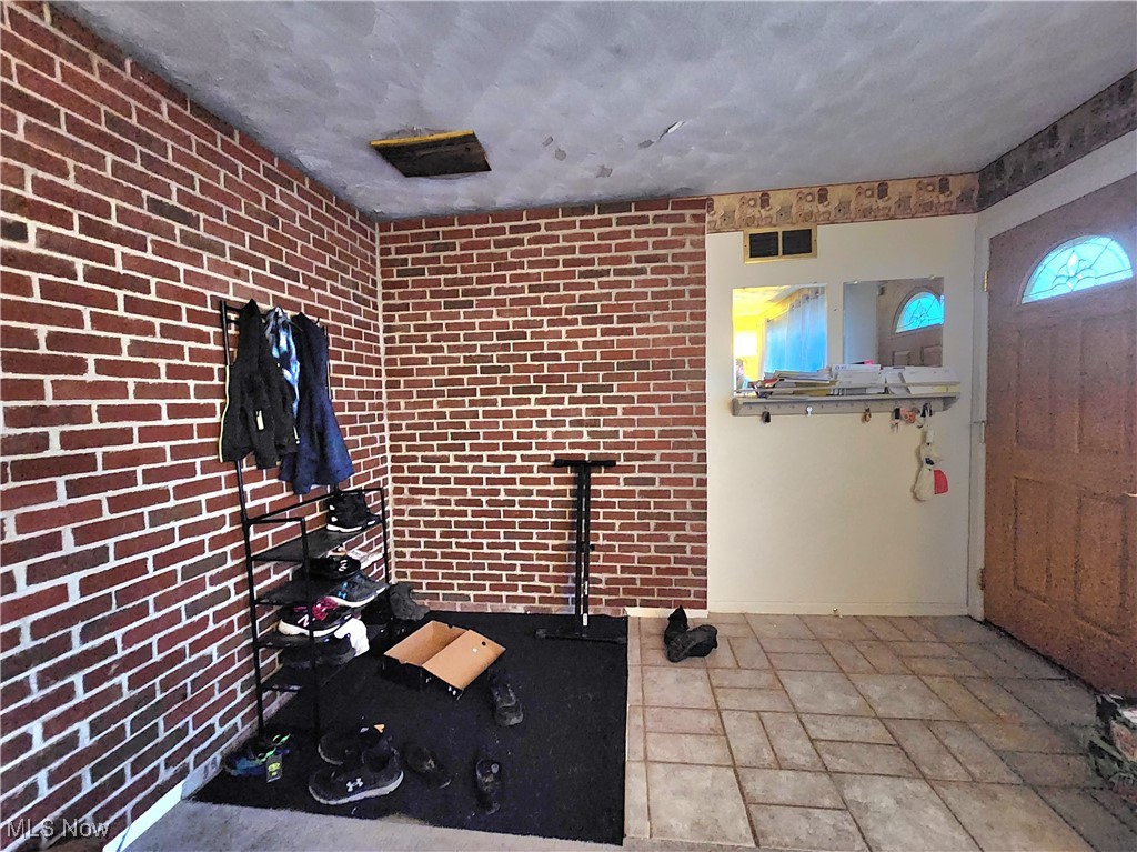 6280 Virginia Road Nashport, OH 43830 - Photo 4 of 14 Workout area featuring brick wall and a textured ceiling