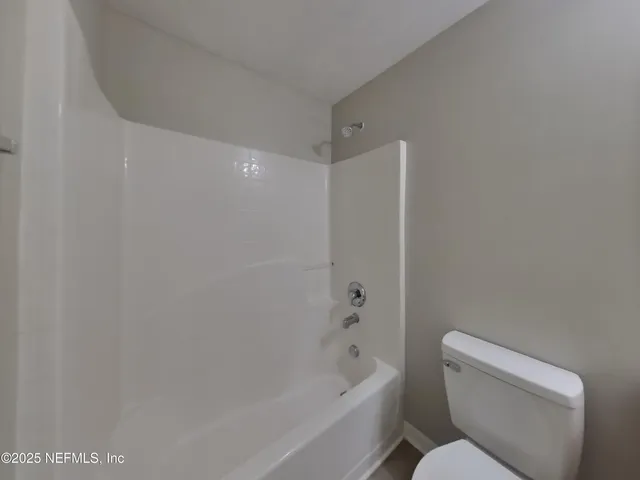 a bathroom with a toilet and a bathtub