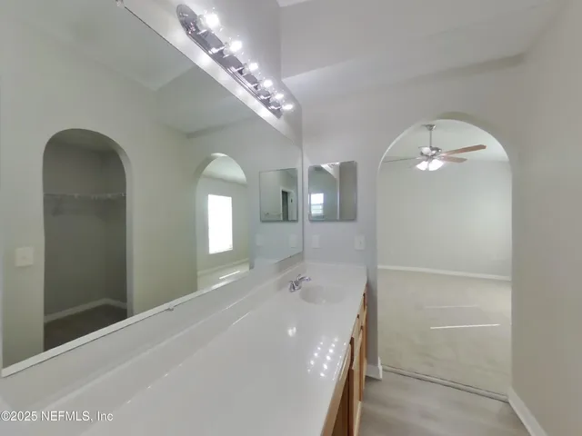a spacious bathroom with a double vanity sink and a mirror