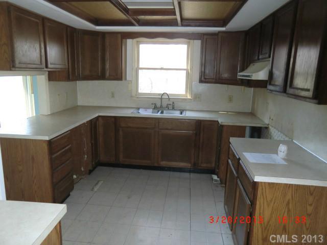 4008 Wynbrook Way Monroe, NC 28112 - Photo 5 of 15 a kitchen with a sink a stove and cabinets