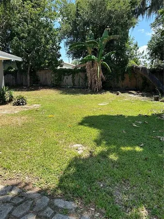 a swimming pool with outdoor seating and yard