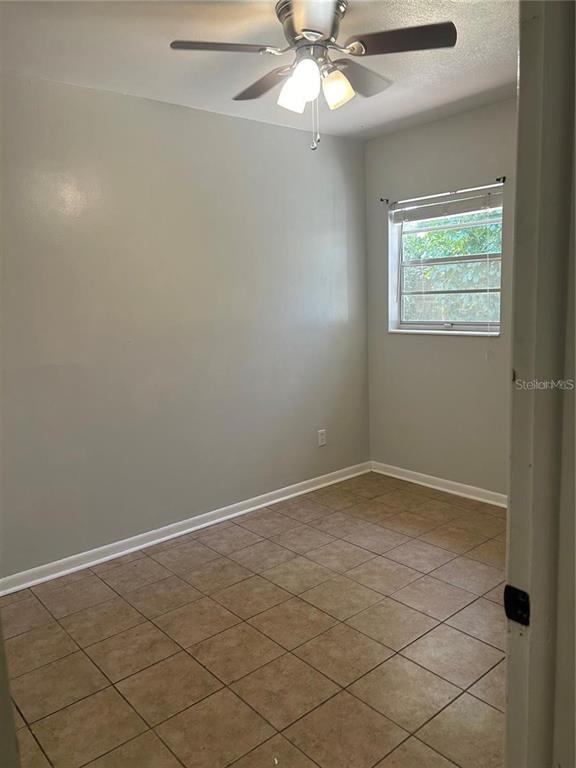 232 Beverly Boulevard Brandon, FL 33511 - Photo 26 of 32 an empty room with a chandelier fan