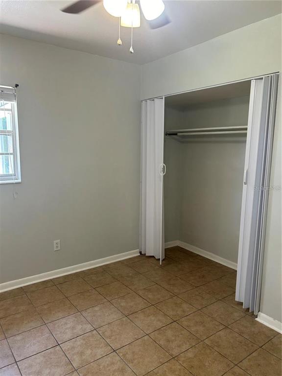 232 Beverly Boulevard Brandon, FL 33511 - Photo 27 of 32 an empty room with a chandelier fan