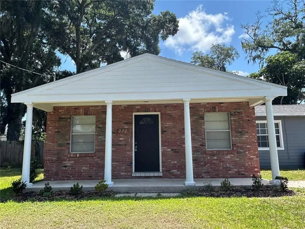 a view of house with yard