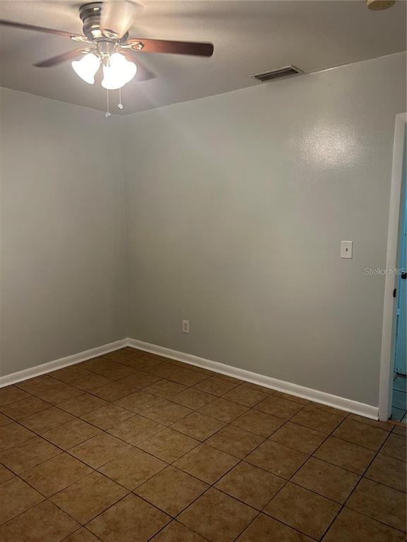 232 Beverly Boulevard Brandon, FL 33511 - Photo 31 of 32 an empty room with a chandelier fan