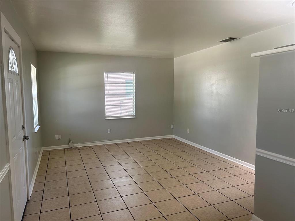 232 Beverly Boulevard Brandon, FL 33511 - Photo 5 of 32 an empty room with white walls and tiles