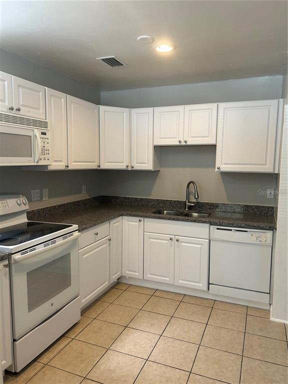 232 Beverly Boulevard Brandon, FL 33511 - Photo 7 of 32 a kitchen with granite countertop white cabinets stainless steel appliances and sink