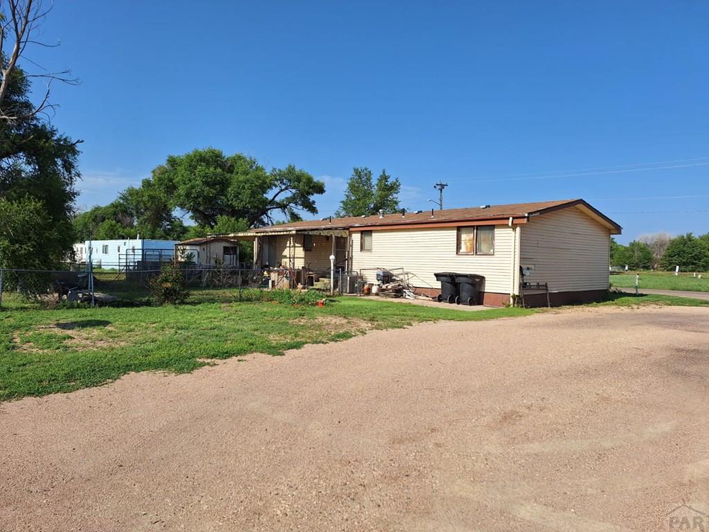 503 Division Street Lamar, CO 81052 - Photo 8 of 11 a front view of house with yard and garage