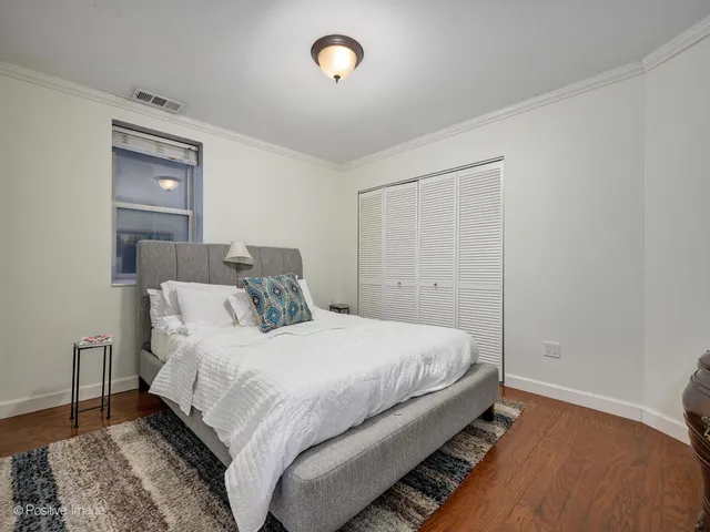 a bedroom with a bed and a lamp