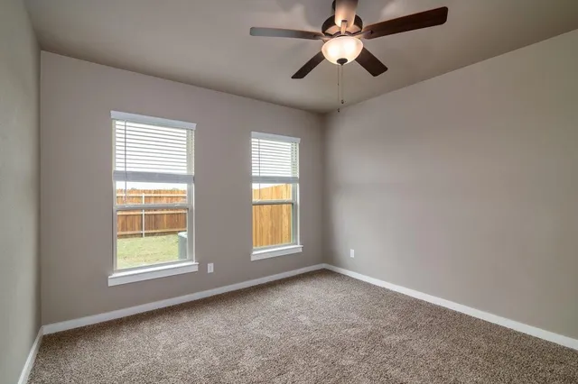 a view of room with a ceiling fan and window