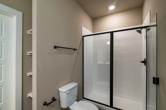 a bathroom that has a glass shower door