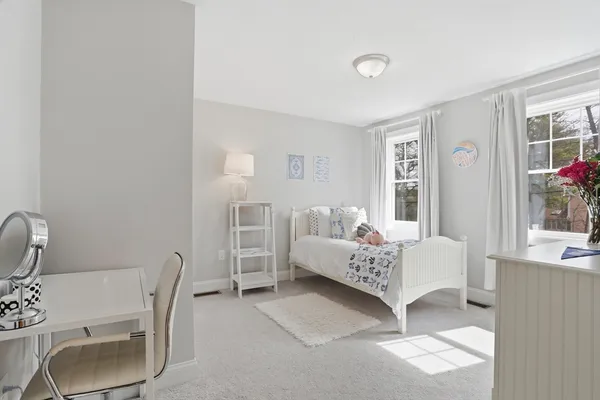 a bedroom with a bed and a chair