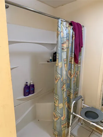 a bathroom with a bathtub and shower