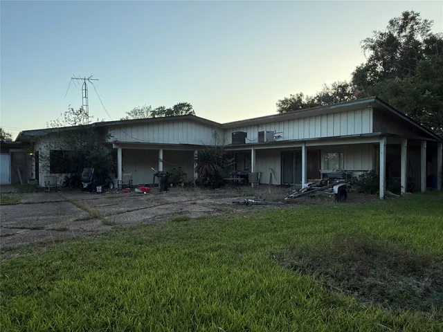 a front view of a house with a garden and patio