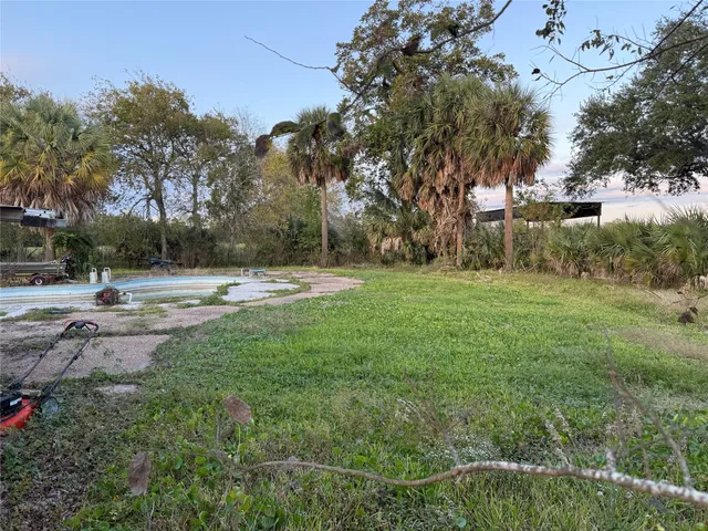 a view of outdoor space with green field and trees