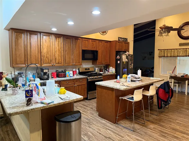a kitchen with a sink appliances and cabinets