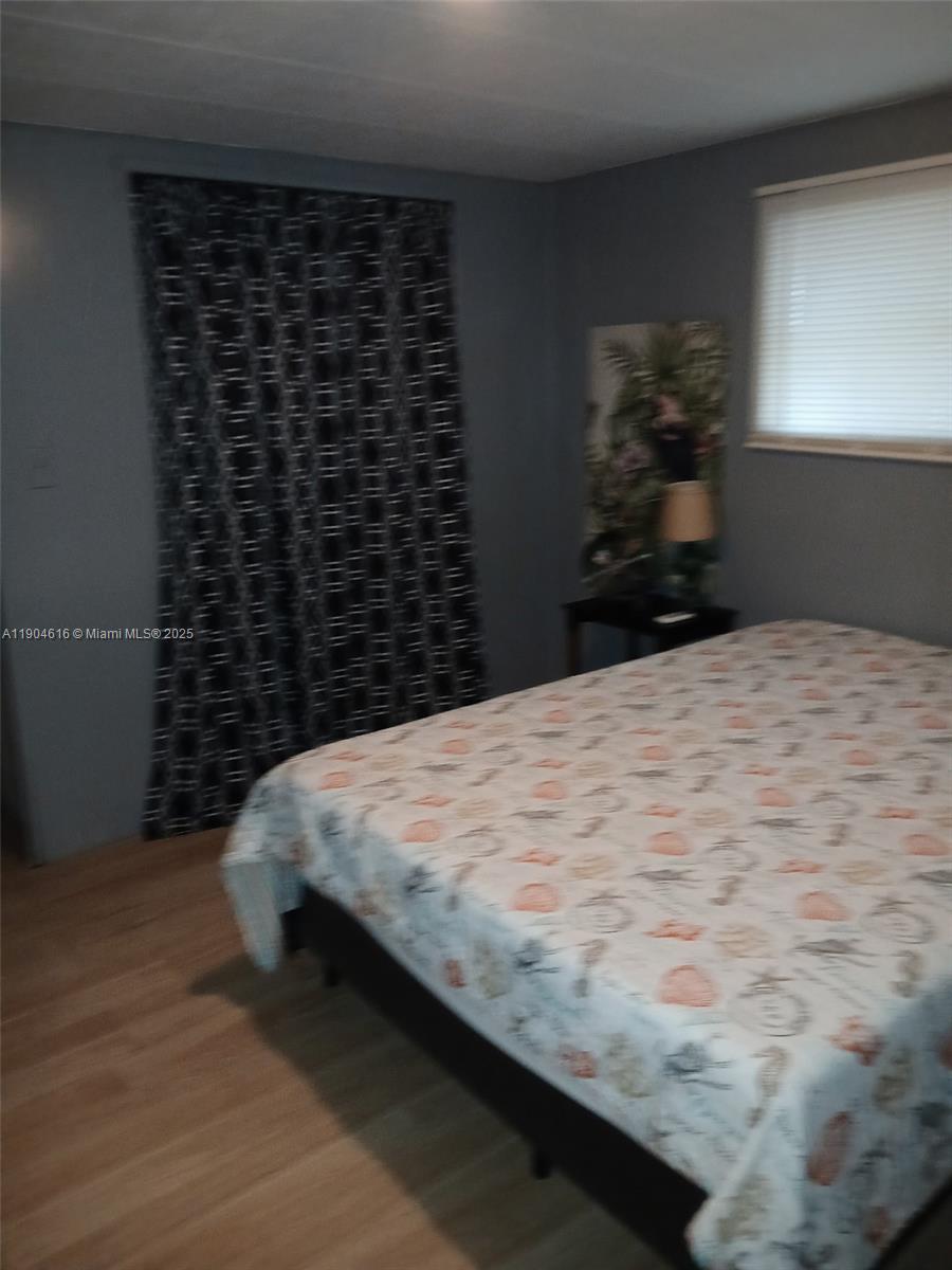 1860 Southwest 83rd Terrace Davie, FL 33324 - Photo 8 of 12 a bed sitting in a bedroom next to a window