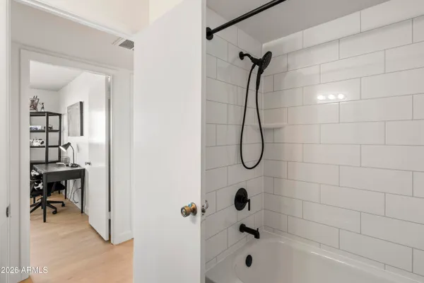 a bathroom with a bath tub with a shower