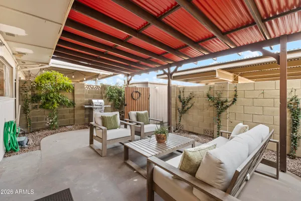 a outdoor space with patio lots of furniture and large windows