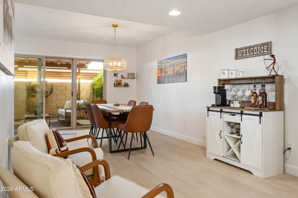 a dining room with furniture and a floor to ceiling window