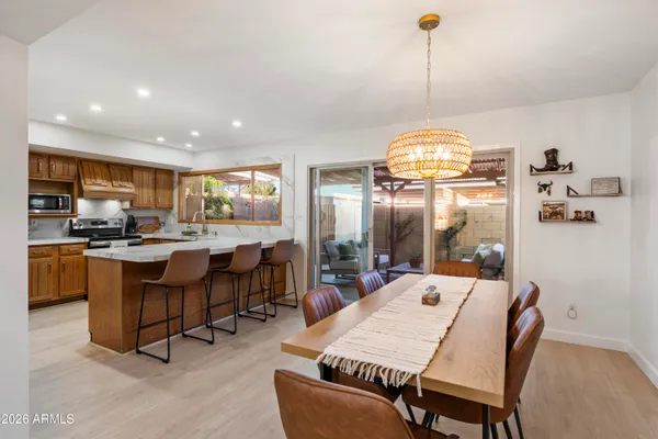 a kitchen island with stainless steel appliances kitchen island granite countertop a sink and a refrigerator