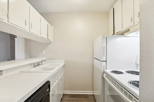 a utility room with cabinets washer and dryer
