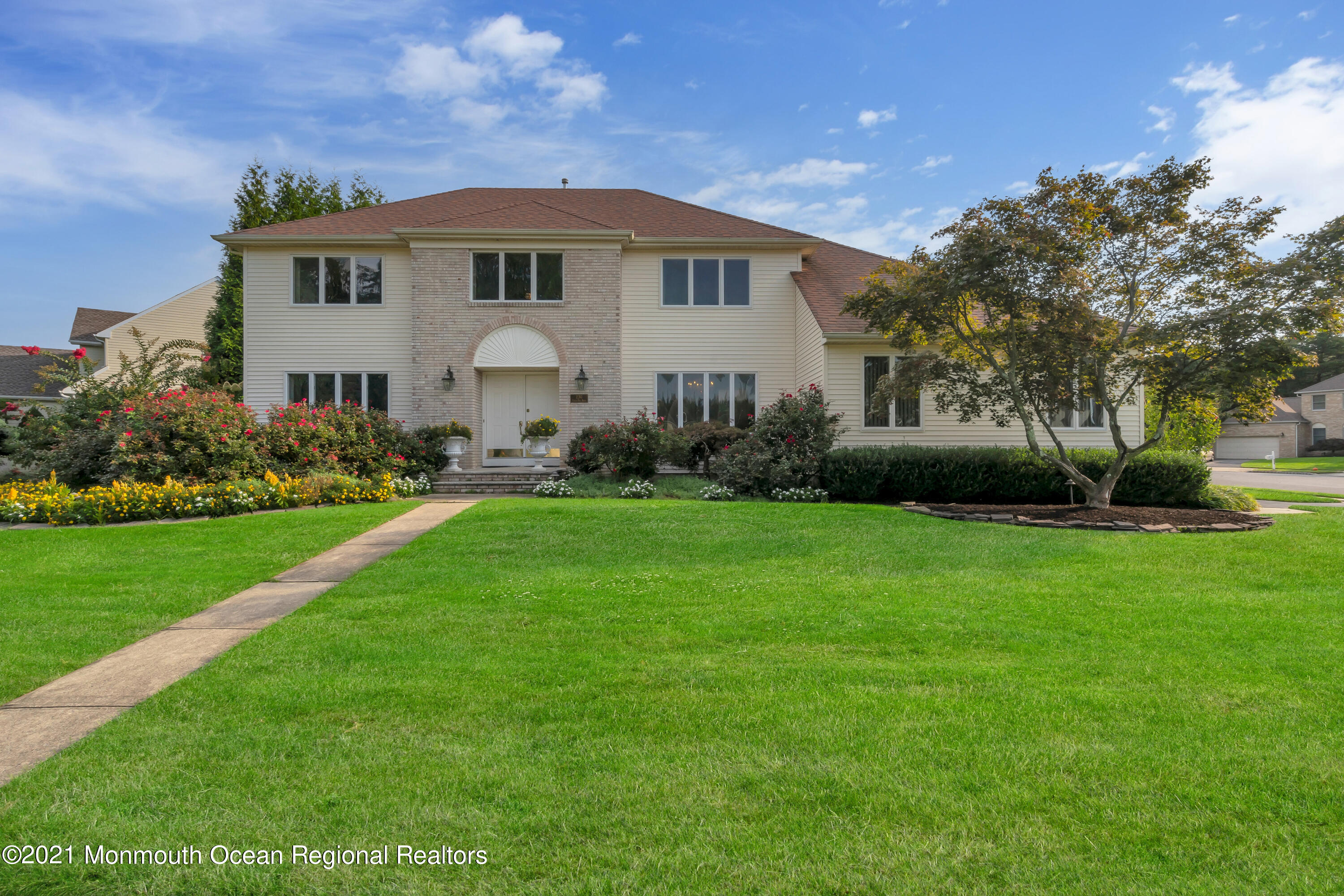 a front view of house with yard and green space