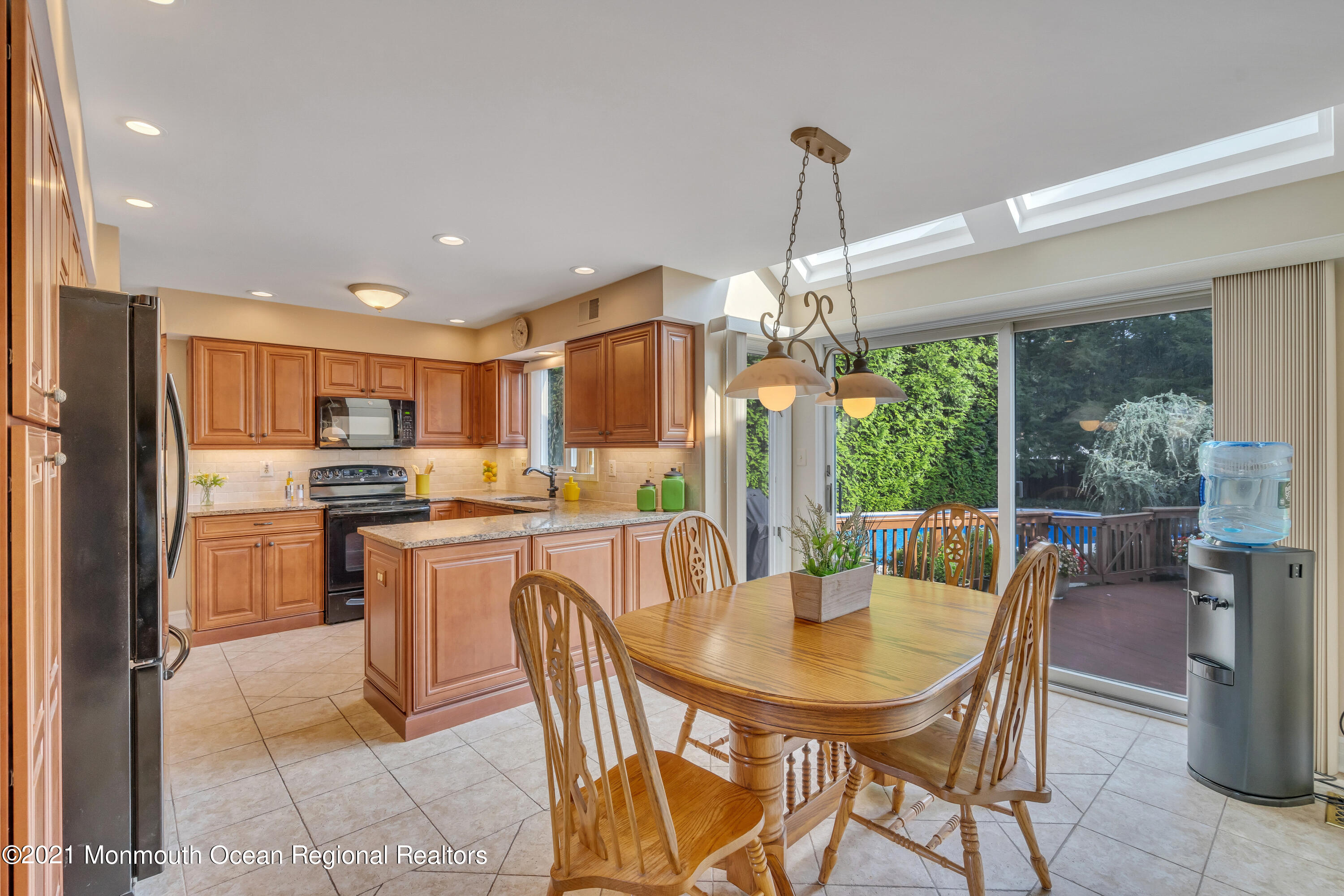 230 Crest Hill Road Toms River, NJ 08755 - Photo 19 of 59 a dining room with a table chairs and a kitchen view