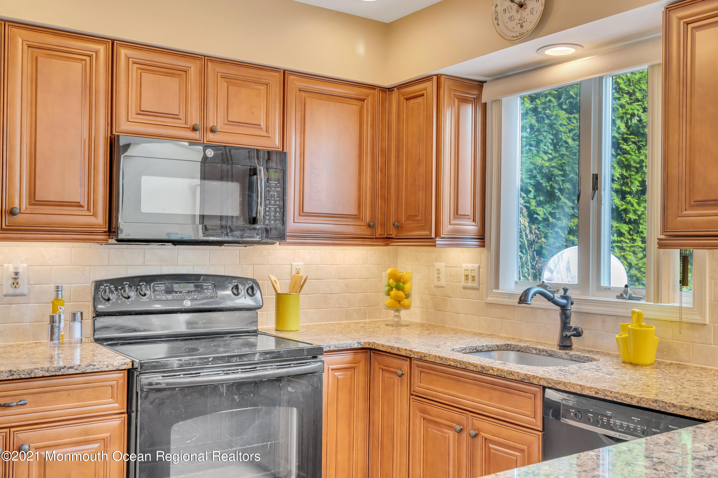 230 Crest Hill Road Toms River, NJ 08755 - Photo 23 of 59 a kitchen with granite countertop a sink a stove and cabinets