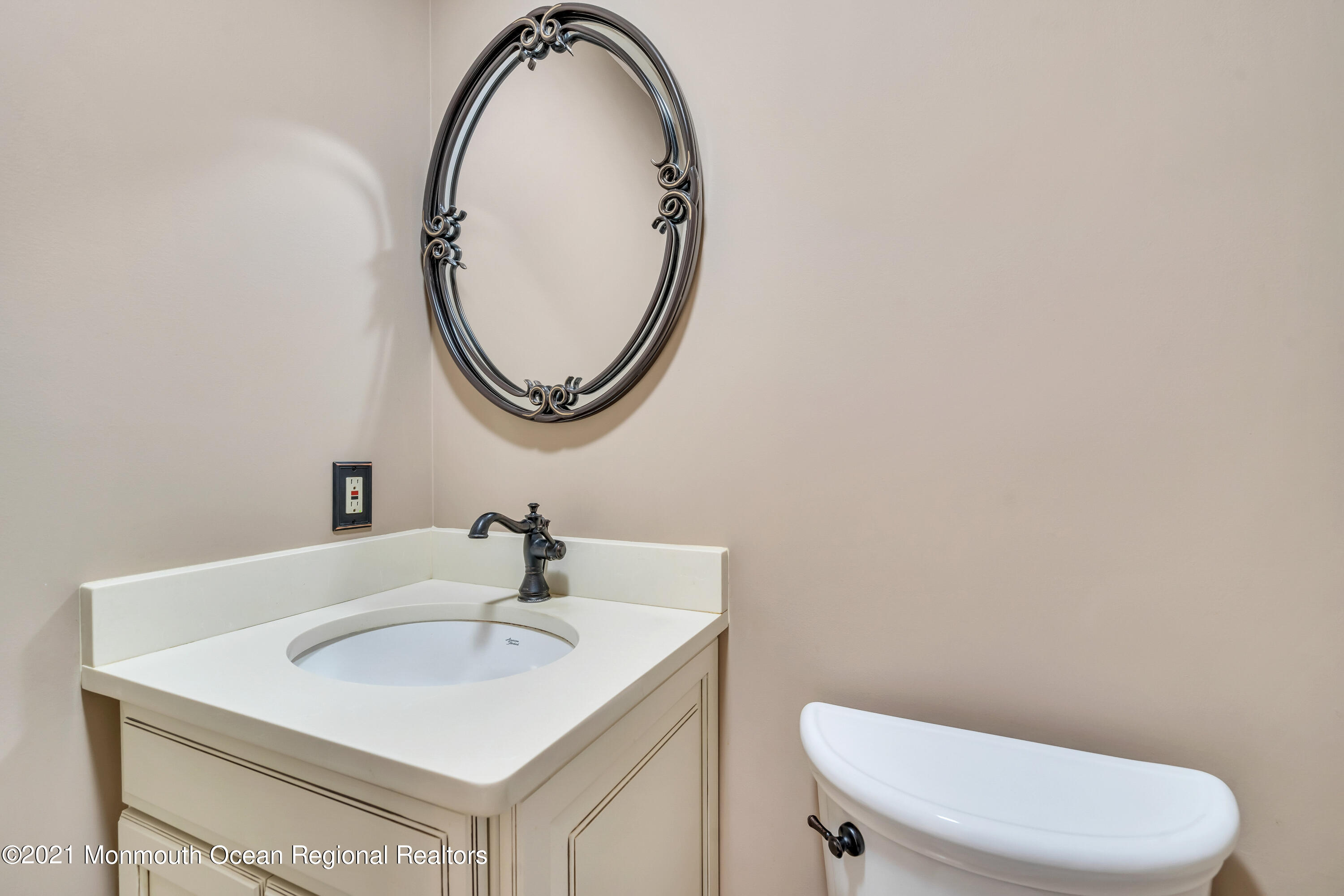 230 Crest Hill Road Toms River, NJ 08755 - Photo 30 of 59 a bathroom with a sink a toilet and a mirror