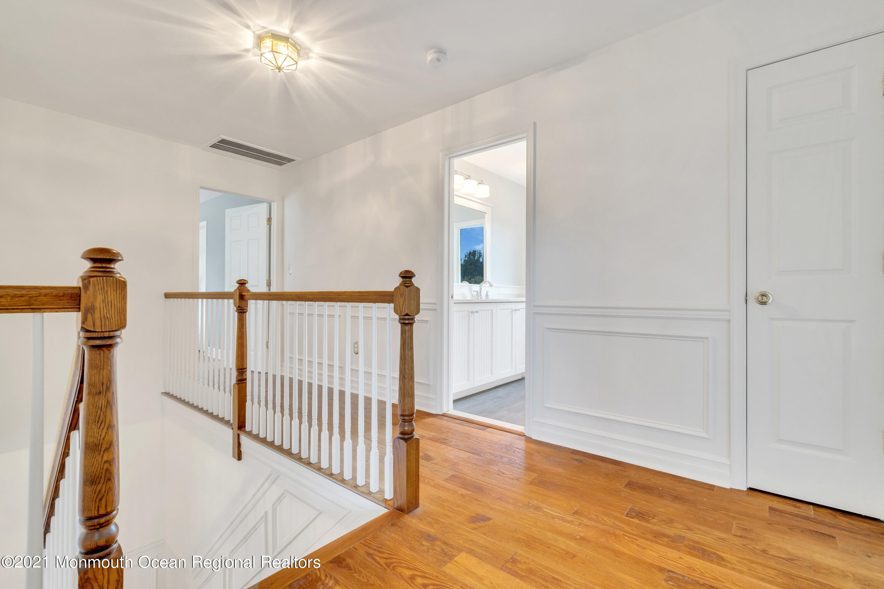 230 Crest Hill Road Toms River, NJ 08755 - Photo 33 of 59 a view of a room with wooden floor stairs and a chandelier fan