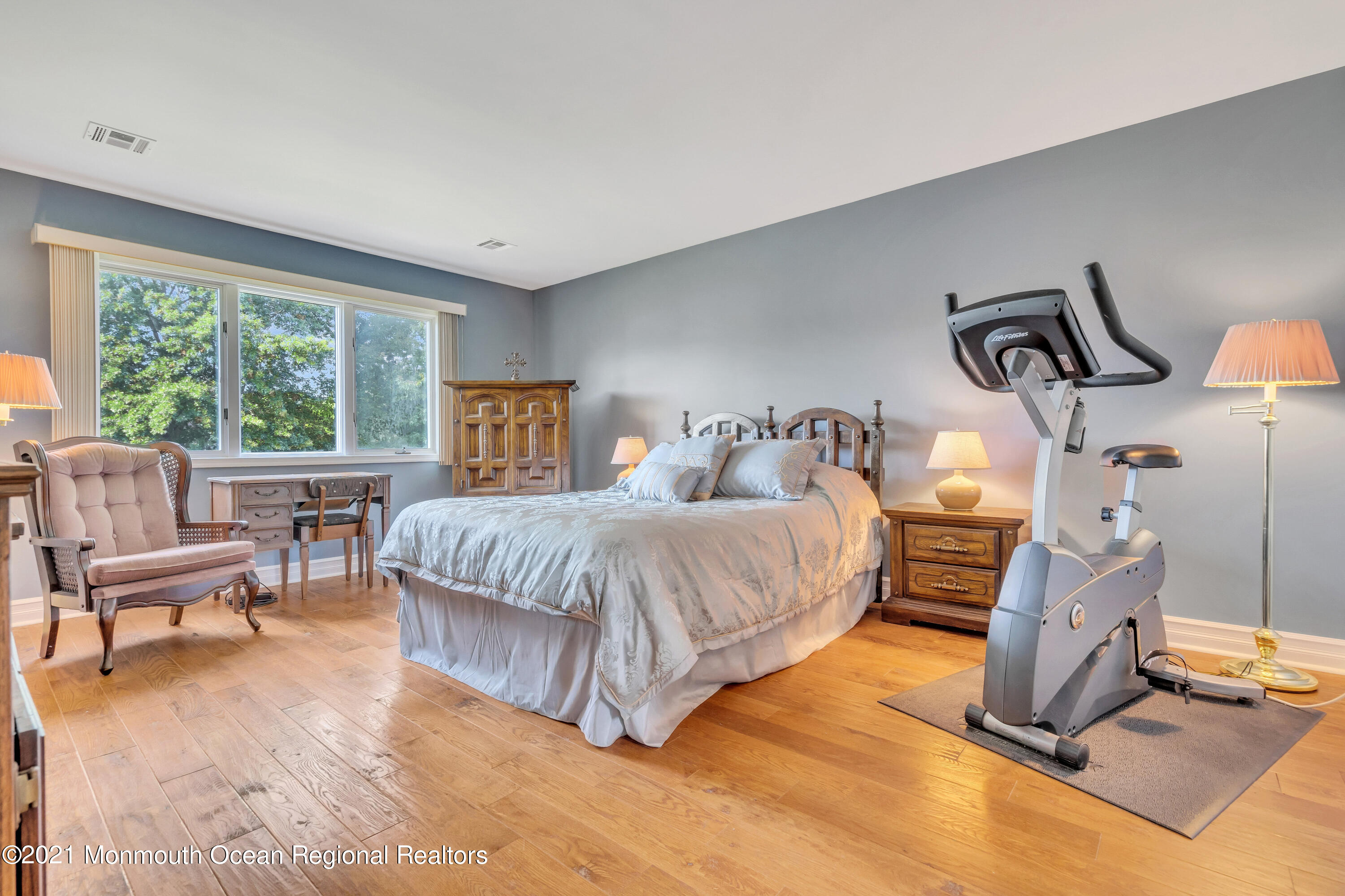 230 Crest Hill Road Toms River, NJ 08755 - Photo 34 of 59 a bedroom with a bed a mirror and lamp next to a large window