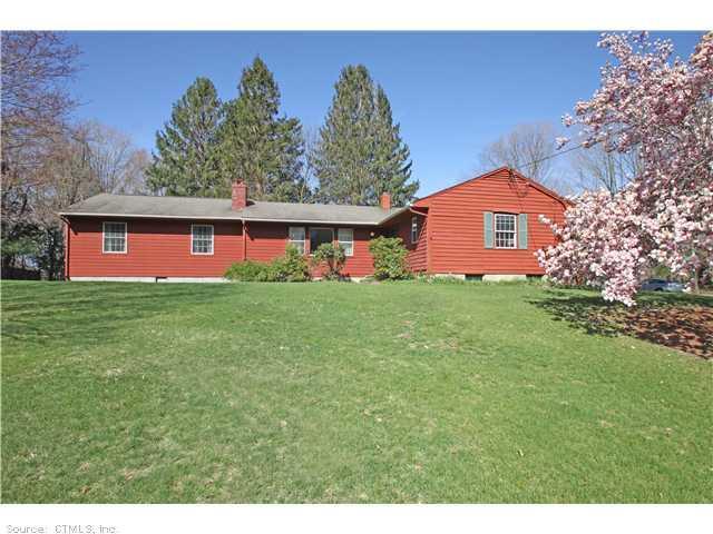 16 Poverty Hollow Road Newtown, CT 06470 - Photo 1 of 1 a front view of house with yard and trees in the background