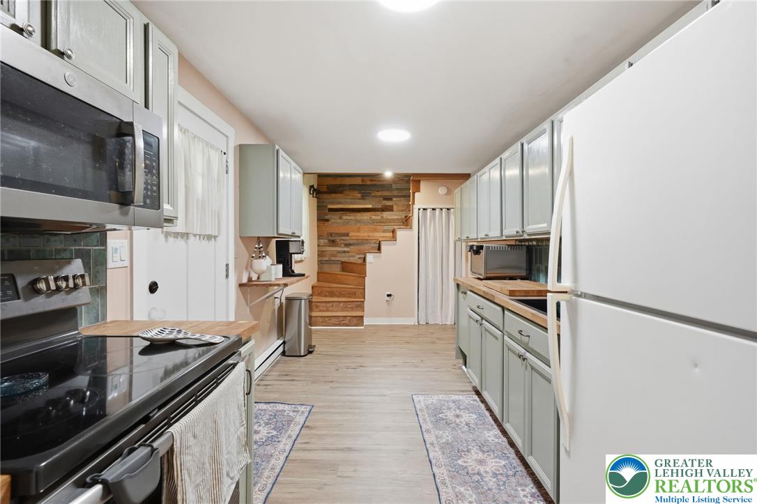 9033 Loop Road Slatington, PA 18080 - Photo 6 of 53 A galley kitchen with abundant cabinetry and light wood-tone countertops, perfect for culinary endeavors.